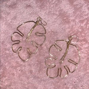 gold earrings shaped like an leaf